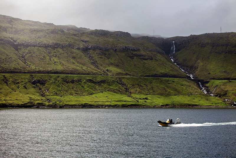 The beauty of the Faroe Islands, with a small boat cruising in clear water. Photo credit: Enric Gener / Sea Shepherd Global